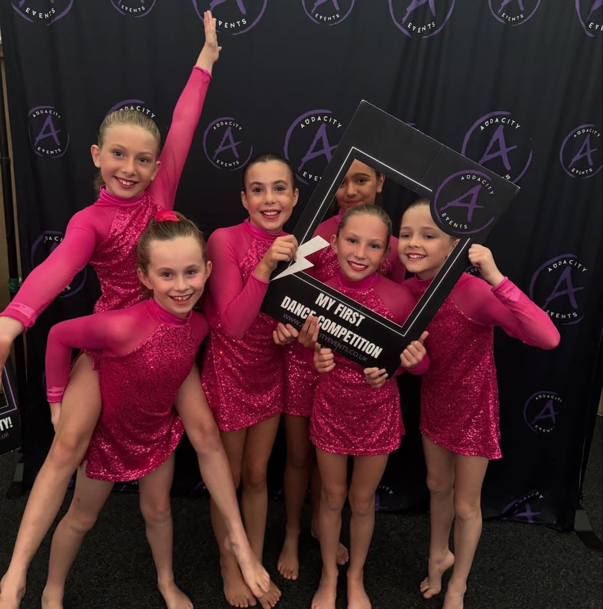 Zest Dance competition team in pink costumes at Addacity