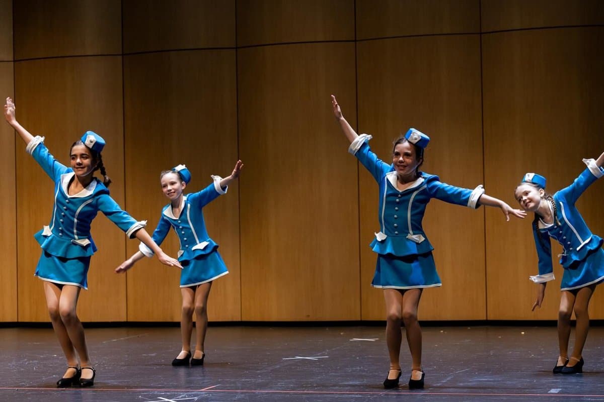 Airline-themed group routine on stage