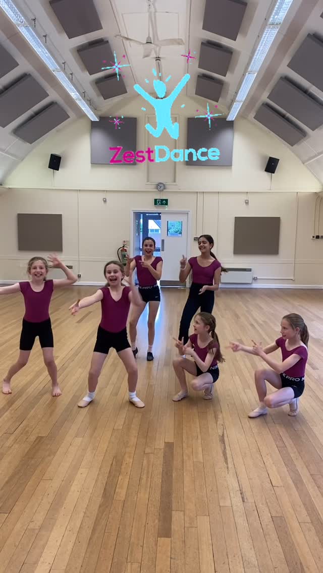 Group of children standing together in a dance studio ready to begin class