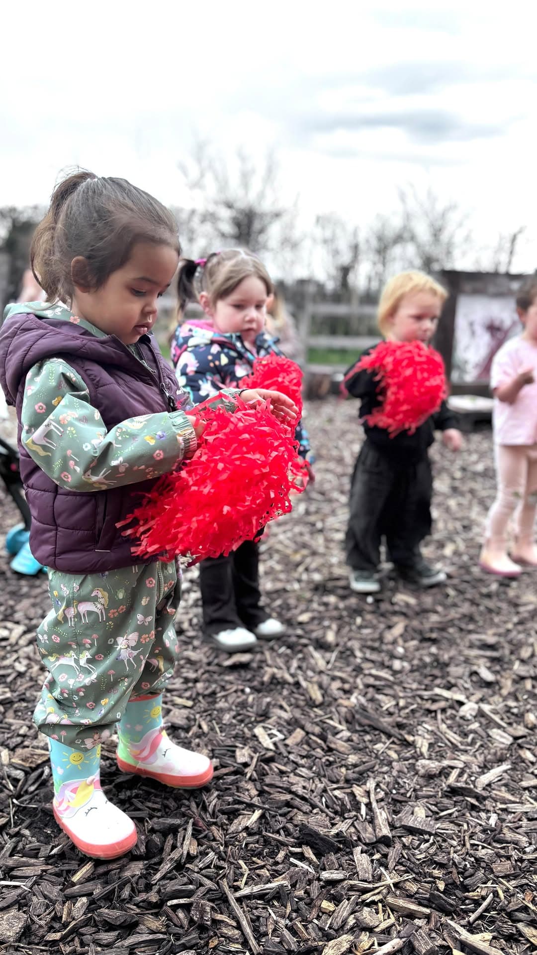 Toddler with red pompoms at Zest Dance